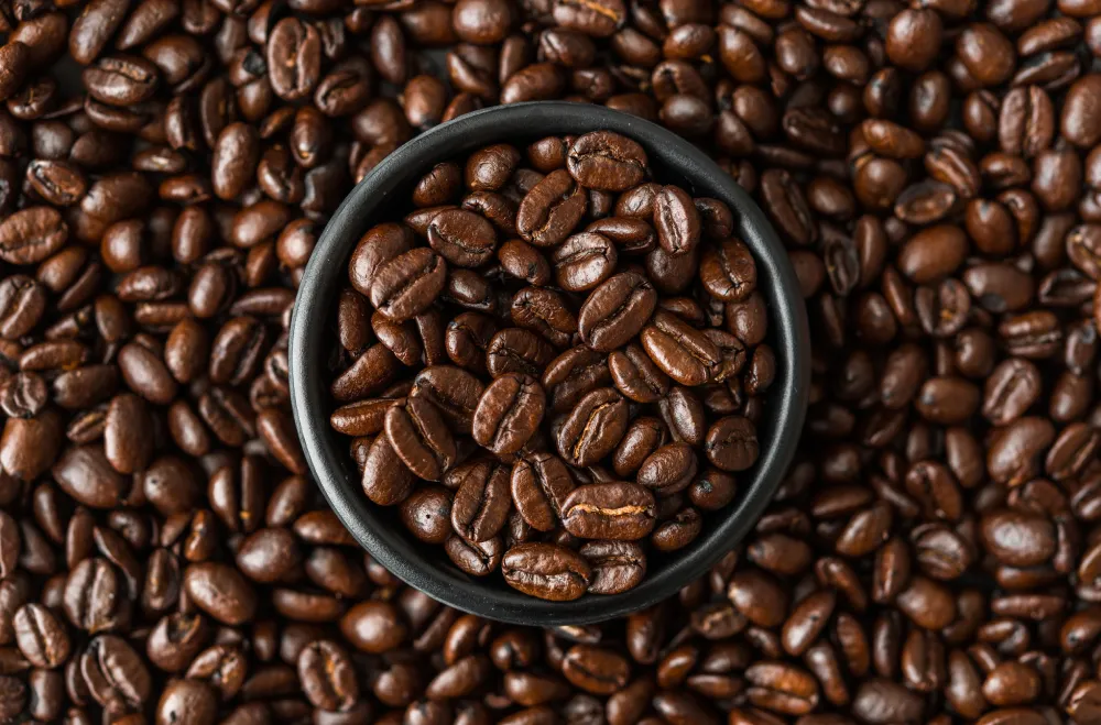 photo of coffee beans Roasted coffee beans in a black bowl